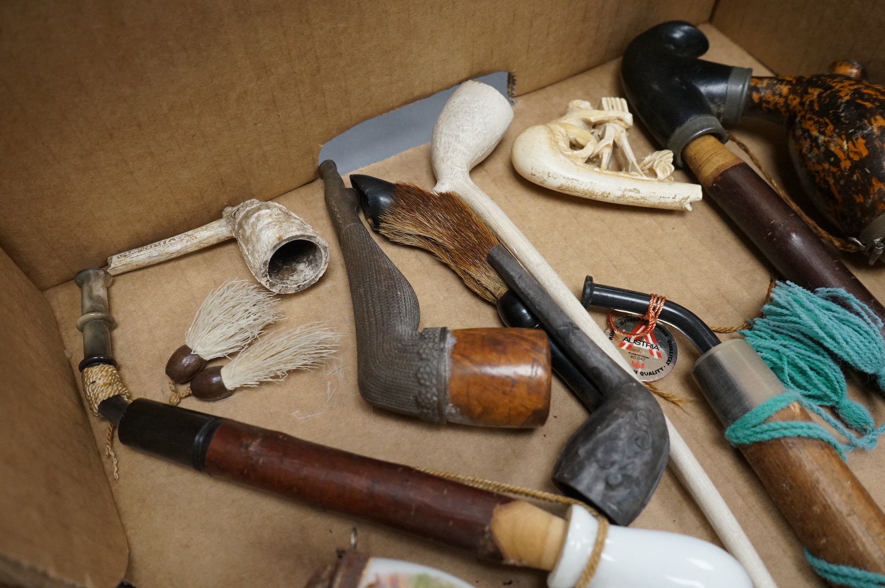 A group of fifteen novelty pipes to include treen, clay and ceramic examples